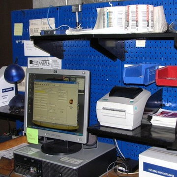 Blue industrial metal peg boards being used to create a shipping station with to