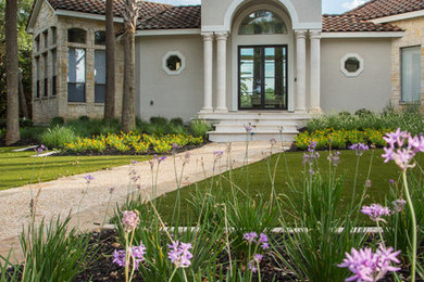 This is an example of a large mediterranean drought-tolerant and full sun front yard stone walkway in Other for summer.
