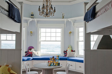 Design ideas for a large beach style gender-neutral kids' bedroom for kids 4-10 years old in Portland Maine with blue walls and dark hardwood floors.