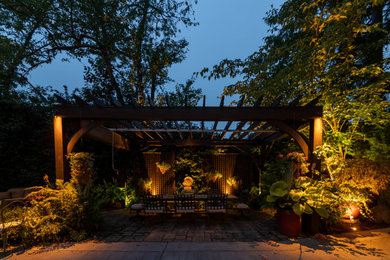 Mid-sized elegant backyard patio photo in Seattle with a pergola
