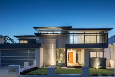 Photo of a large modern two-storey stucco grey house exterior in Perth with a flat roof and a metal roof.