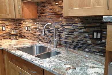 Eat-in kitchen - mid-sized traditional l-shaped eat-in kitchen idea in Other with an undermount sink, shaker cabinets, light wood cabinets, granite countertops, multicolored backsplash, mosaic tile backsplash, stainless steel appliances and no island