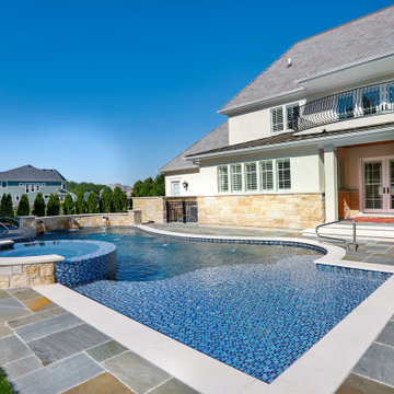 Naperville, IL freeform swimming pool with hot tub, large sunshelf, glass tile