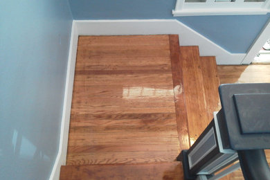 Elegant wooden u-shaped staircase photo in Other with wooden risers