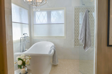 Design ideas for a transitional bathroom in Denver with a freestanding tub, a curbless shower and beige tile.