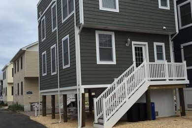 Large elegant gray three-story concrete fiberboard flat roof photo in New York