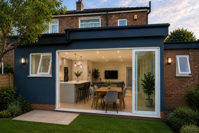 Inspiration for a medium sized contemporary render and rear house exterior in Other with a flat roof.