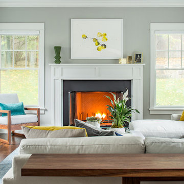 A black fireplace counters the white and wood living room