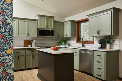 Inspiration for a mid-sized transitional u-shaped vinyl floor and brown floor eat-in kitchen remodel in Minneapolis with an undermount sink, shaker cabinets, green cabinets, quartz countertops, white backsplash, ceramic backsplash, stainless steel appliances, an island and white countertops