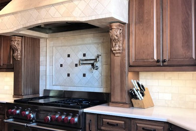 This is an example of a transitional kitchen in Phoenix with raised-panel cabinets, quartz benchtops and beige benchtop.