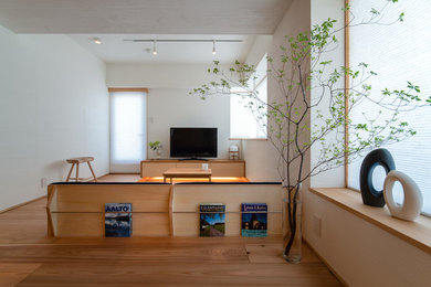 Inspiration for a small scandinavian living room in Other with beige walls, medium hardwood floors, a freestanding tv and beige floor.
