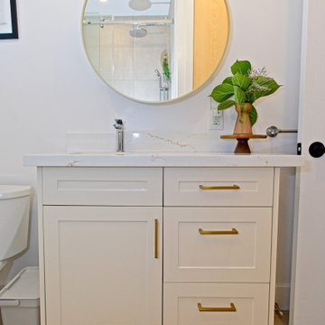 Custom White Vanity with Round Gold-Framed Mirror | The Junction