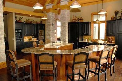 Eat-in kitchen - mid-sized rustic single-wall dark wood floor and brown floor eat-in kitchen idea in Kansas City with a single-bowl sink, raised-panel cabinets, black cabinets, beige backsplash, two islands, travertine backsplash and paneled appliances