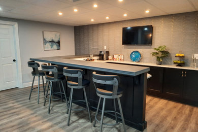 Inspiration for a large modern laminate floor and beige floor home bar remodel in Philadelphia