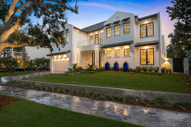 Large transitional white two-story stucco exterior home idea in Miami with a tile roof