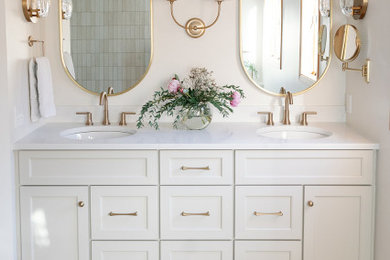 Inspiration for a large transitional master white tile and porcelain tile porcelain tile, white floor and double-sink freestanding bathtub remodel in Other with shaker cabinets, white cabinets, white walls, an undermount sink, quartz countertops, a hinged shower door, white countertops, a niche and a built-in vanity