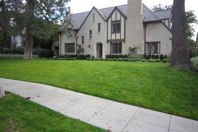 Inspiration for a beige two-story brick gable roof remodel in Los Angeles