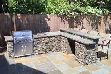 Photo of a traditional backyard patio in DC Metro with an outdoor kitchen.