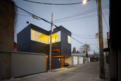На фото: маленький, двухэтажный, кирпичный, черный дом в стиле модернизм для на участке и в саду