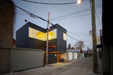 Example of a small minimalist black two-story brick exterior home design in Toronto