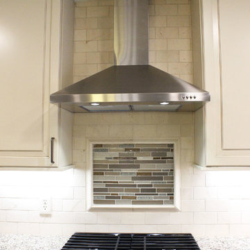 Beige Kitchen with Extra Large Island, Tile Backsplash and Granite Countertops