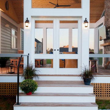 Design Builders screened porch with stone fireplace & Ipe deck in Sykesville MD