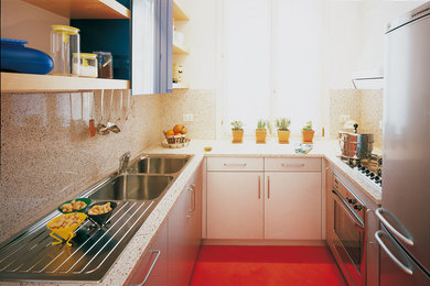 Enclosed kitchen - small contemporary u-shaped painted wood floor and red floor enclosed kitchen idea in Philadelphia with a double-bowl sink, flat-panel cabinets, white cabinets, quartz countertops, beige backsplash, stone slab backsplash, stainless steel appliances and no island