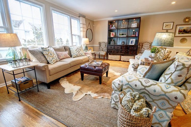 Example of a large transitional open concept light wood floor family room design in DC Metro with beige walls, a standard fireplace and a wall-mounted tv