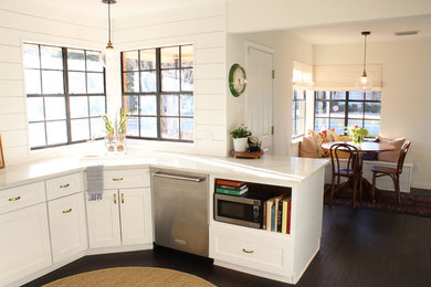 Eat-in kitchen - small traditional u-shaped dark wood floor and brown floor eat-in kitchen idea in Dallas with a single-bowl sink, shaker cabinets, white cabinets, quartzite countertops, white backsplash, wood backsplash, stainless steel appliances and no island