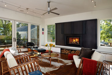 Example of a trendy formal medium tone wood floor living room design in DC Metro with white walls, a ribbon fireplace, a metal fireplace and no tv