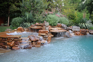 A gorgeous natural boulder pool with spa, waterfall, and romantic grotto.