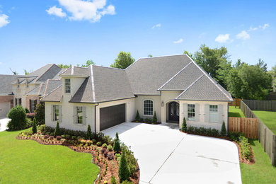 Inspiration for a transitional white two-story brick exterior home remodel in New Orleans with a hip roof