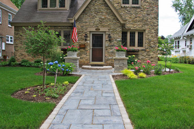 Photo of a small traditional front yard concrete paver landscaping in Milwaukee.