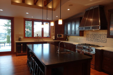 Example of a large arts and crafts eat-in kitchen design in Vancouver with shaker cabinets, dark wood cabinets and an island