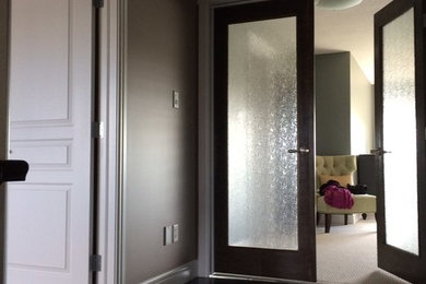 Example of a mid-sized classic dark wood floor and brown floor hallway design in Edmonton with gray walls