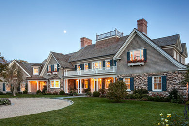 Example of a transitional gray three-story stone gable roof design in New York
