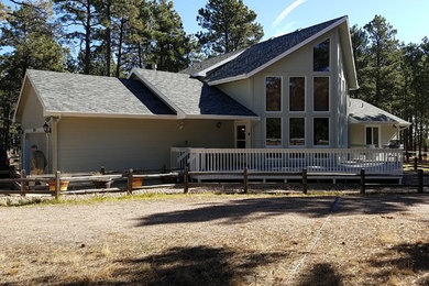 Mid-sized two-story mixed siding exterior home idea in Other