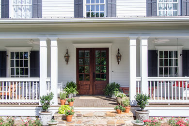 Country white two-story exterior home photo in Other with a metal roof