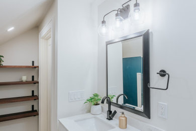 Example of a small master vinyl floor, brown floor and single-sink bathroom design in Portland with recessed-panel cabinets, white cabinets, blue walls, an integrated sink, quartz countertops, white countertops and a built-in vanity