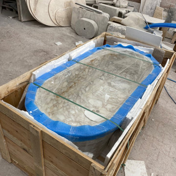 Sculptural Calacatta Gold Marble Bathroom with Hand-Carved Bathtub