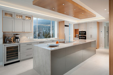 Large transitional l-shaped kitchen in Vancouver with grey cabinets, granite benchtops, stainless steel appliances, ceramic floors, with island and white floor.