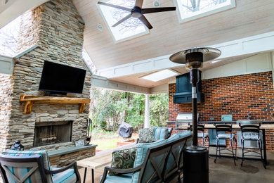 Large transitional concrete porch idea in Charlotte with a roof extension