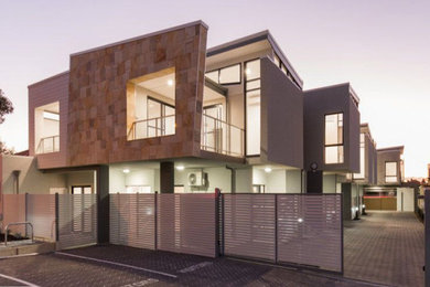 Small contemporary two-storey apartment exterior in Perth with a metal roof and a grey roof.