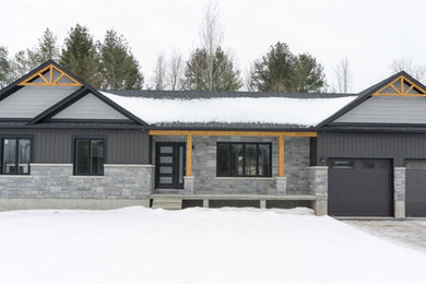 Example of a mountain style gray one-story house exterior design in Ottawa