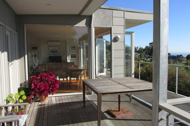 Inspiration for a small contemporary balcony in Melbourne with a roof extension.