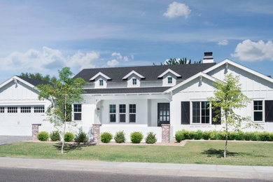 Large farmhouse white one-story board and batten exterior home idea in Phoenix with a black roof