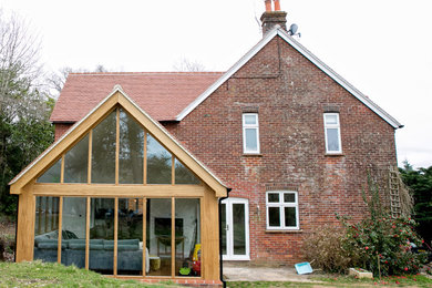 This is an example of a rural house exterior in Hampshire with wood cladding.