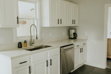 Design ideas for a small classic galley kitchen/diner in Detroit with a submerged sink, shaker cabinets, white cabinets, engineered stone countertops, white splashback, engineered quartz splashback, stainless steel appliances, ceramic flooring, no island, black floors and white worktops.