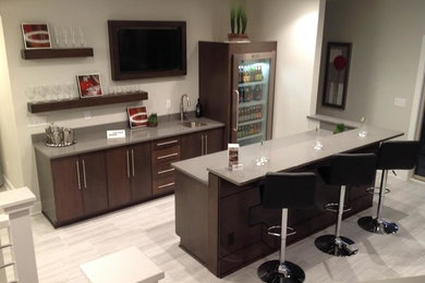 Large elegant galley porcelain tile and beige floor seated home bar photo in Other with an undermount sink, flat-panel cabinets, dark wood cabinets, granite countertops and white backsplash