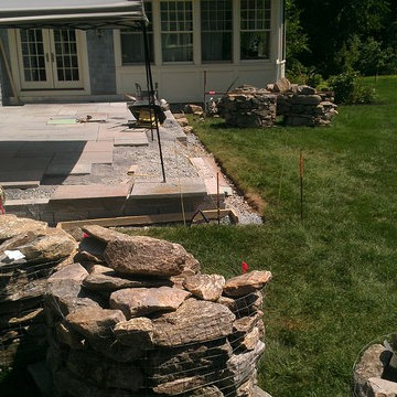 Blue stone patio and New England fieldstone capped sitting wall